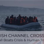An extremely overcrowded grey inflatable dinghy, packed tightly with dozens of migrants, many wearing orange life vests, navigates dark, choppy waters with a prominent white cliff formation under a dramatic, overcast grey sky in the background.